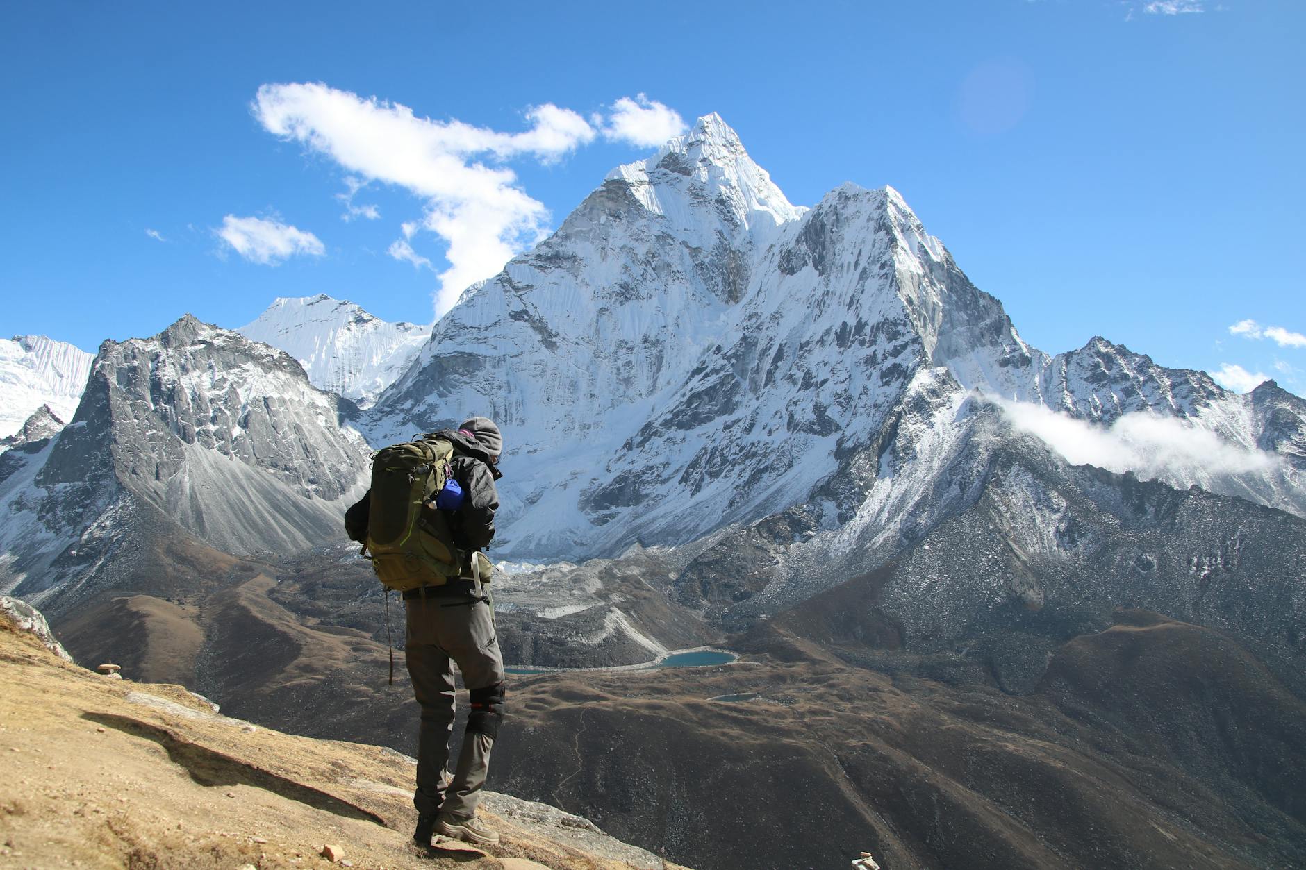 man with backpack hiking in mountains