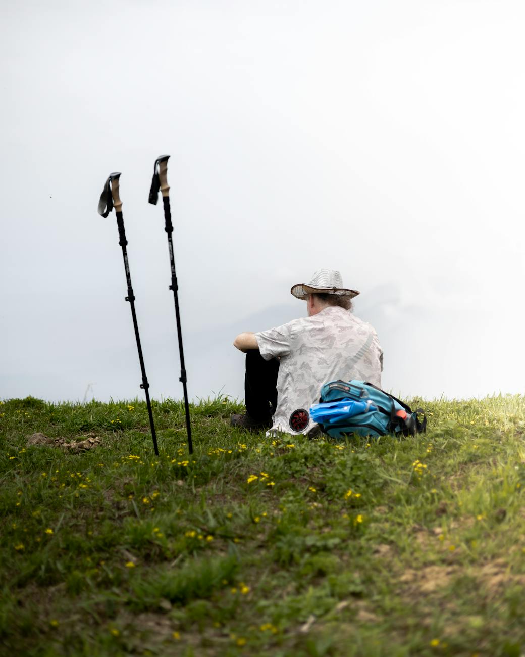 a traveler sits on the grass and relaxes